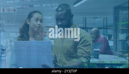Image of financial data processing over diverse business people using laptop Stock Photo