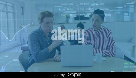 Image of financial data processing over diverse business people using laptop Stock Photo