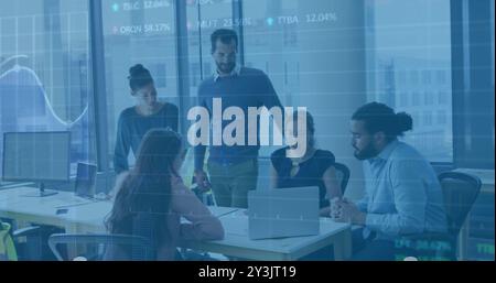 Image of financial data processing over diverse business people using laptop Stock Photo