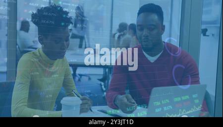 Image of financial data processing over diverse business people using laptop Stock Photo
