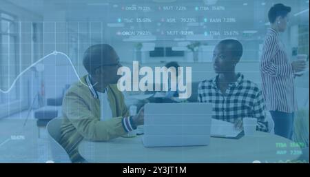 Image of financial data processing over diverse business people using laptop Stock Photo