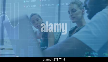 Image of financial data processing over diverse business people using laptop Stock Photo