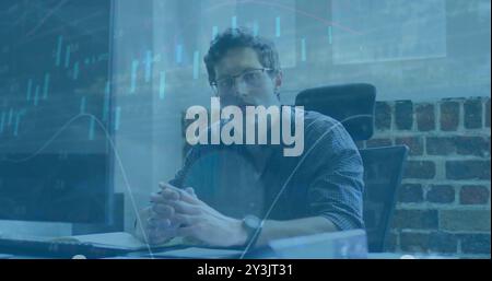 Image of financial data processing over caucasian businessman in office Stock Photo