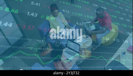 Image of financial data processing over diverse business people in office Stock Photo