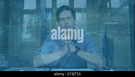 Image of financial data processing over caucasian businessman in office Stock Photo