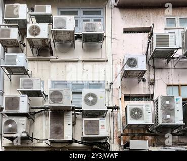 Singapore, 1 June 2024: many air-cons on the back-street facade of commercial buildings and restaurants in Singapore's Boat Quay area. Stock Photo