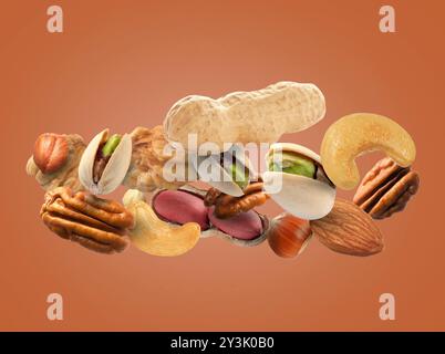 Pecan and other nuts in air on brown background Stock Photo
