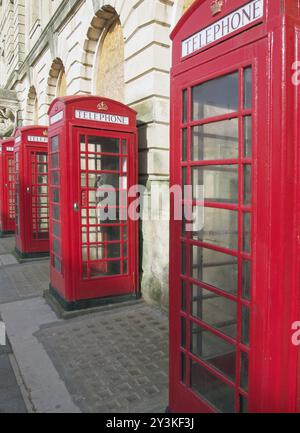 A line of typical old fashioned british red public telephone boxes outside the former post office in Blackpool Lancashire Stock Photo