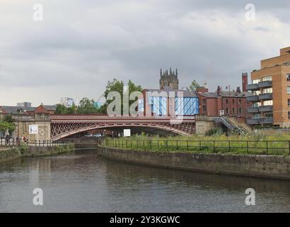 Leeds, west yorkshire, united kingdom, 10 july 2019: riverside view of crown point bridge crossing the canal and aire in leeds with people on the wate Stock Photo