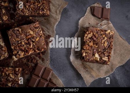 Delicious homemade chocolate cake decorated with walnuts. Freshly baked brownie cake on a rustic wooden table Stock Photo