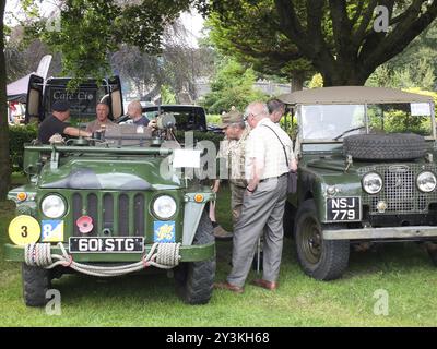 Hebden bridge, west yorkshire, united kingdom, 4 august 2019: men talking around old military vehicles in the public park at hebden bridge annual vint Stock Photo