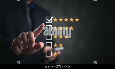 Hand selecting a five-star rating on a digital interface. Symbolizes customer feedback and quality assessment. Suitable for business, service evaluati Stock Photo