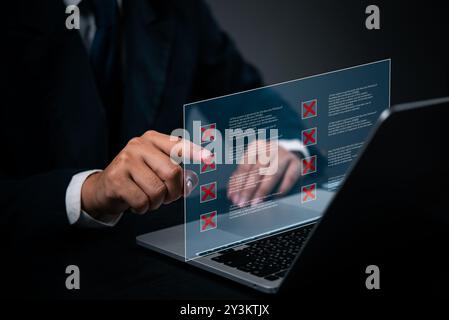 Businessman interacting with digital security hologram displaying red crosses for errors. Highlights cybersecurity and data protection. Ideal for tech Stock Photo