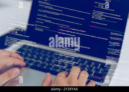 Hands typing code on a laptop, showcasing a software developer at work. Represents process of programming and software development. Ideal for tech blo Stock Photo