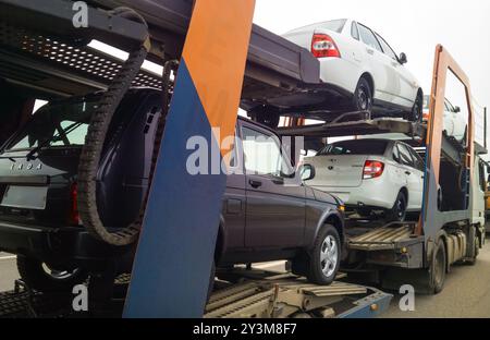 Russian automobles Lada are loaded into the car transportation trailer Stock Photo