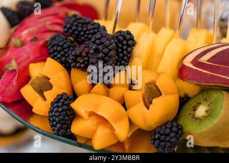 Vibrant Tropical Fruit Medley Displayed on Elegant Platter. Stock Photo