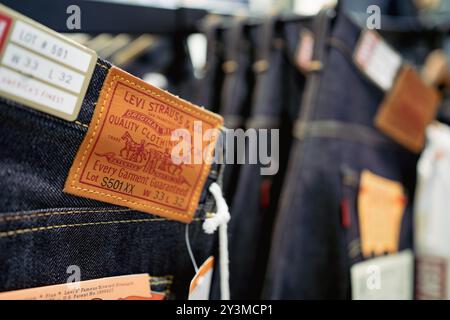 Bangkok, Thailand - September 12, 2024: Levi's 501 jeans hang on shelf in Levi's shop Stock Photo