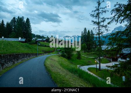 A panoramic view of the picturesque town of Cortina d'Ampezzo, nestled in the heart of the Dolomites. Majestic mountains rise in the background, offer Stock Photo