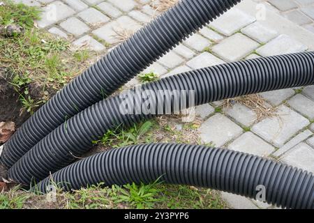 laying corrugated pipes in the ground, industrial pipelines work Stock Photo