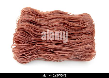 Whole berry rice spaghetti, uncooked and neatly arranged, presented on a white background Stock Photo