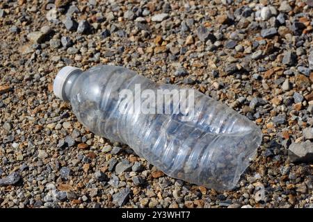 Discarded empty plastic water bottle laying on the ground. Quebec,Canada Stock Photo