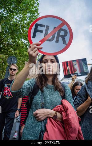 A participant in the march holds a small placard against the use of fur. Activists and supporters of animal rights march through the streets of Warsaw to raise awareness of the dire suffering of animals trapped within factory and industrial farming. The march is billed as an opportunity for the community to unite and make their voices heard, chanting about the importance of equality for animals. Participants began their action at the statue of Copernicus on Nowy Swiat Street. They marched with banners and placards down through the city center, behind the Palace of Culture and Science, and retu Stock Photo