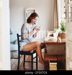 Remote work, laptop and woman with smartphone for online, communication and chat with virtual client. Freelance, female content writer and cellphone Stock Photo