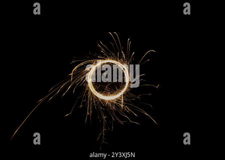 Circular lights with sparks on a black background Stock Photo