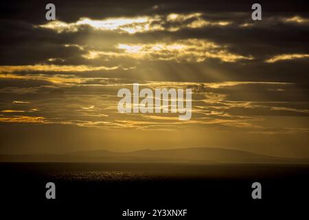 Sunbeams at sunset over the Irish Sea in North Wales Stock Photo