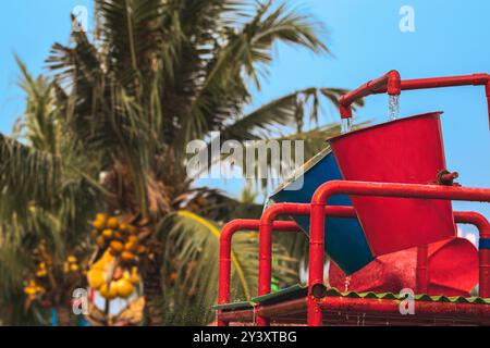 Water spill on water bucket attraction in water park. Water splash on ...