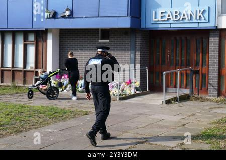 Police officers at Leabank in Luton, Bedfordshire, where three people, believed to be Juliana Prosper, 48, Kyle Prosper, 16, and Giselle Prosper, 13, although formal identification has yet to take place, were found dead in a flat in Leabank, off Wauluds Bank Drive, at around 5.30am on Friday. Nicholas Prosper, 18, of Leabank, Luton, has been charged with the murders of the woman and the two teenagers Bedfordshire Police said. Picture date: Sunday September 15, 2024. Stock Photo