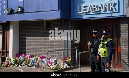 Police officers at Leabank in Luton, Bedfordshire, where three people, believed to be Juliana Prosper, 48, Kyle Prosper, 16, and Giselle Prosper, 13, although formal identification has yet to take place, were found dead in a flat in Leabank, off Wauluds Bank Drive, at around 5.30am on Friday. Nicholas Prosper, 18, of Leabank, Luton, has been charged with the murders of the woman and the two teenagers Bedfordshire Police said. Picture date: Sunday September 15, 2024. Stock Photo