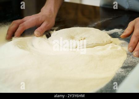 Making a pizza, close up of hands kneading the pizza dough Stock Photo