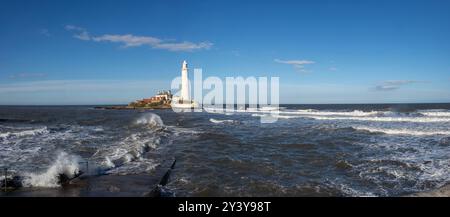 panorama waves crashing at high tide over the causeway to St Marys Lighthouse, Whitley Bay, Stock Photo