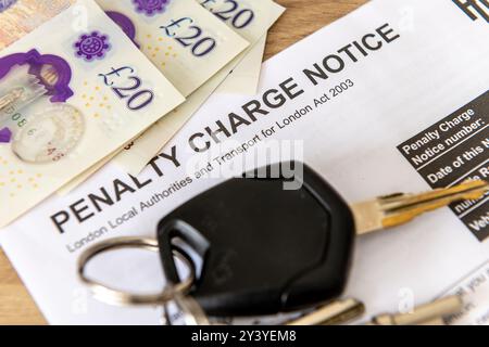Close up of a traffic Penalty Charge Notice with car keys and bank notes. Stock Photo