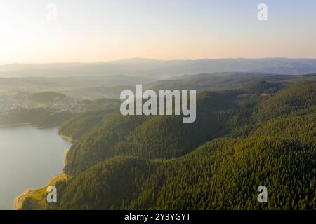 Scenic view of the mountains and the lake in the fog, Bulgaria. Mountain lakes surrounded by forests, aerial shot using a drone Stock Photo