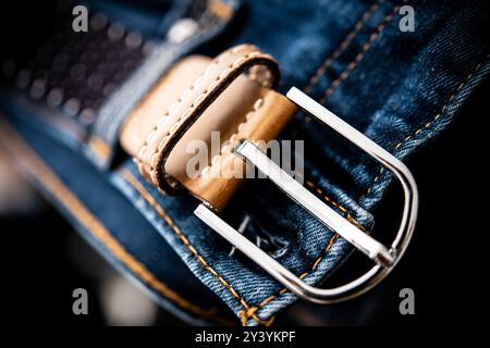 A detailed view of a blue denim belt featuring a stylish silver buckle, adding texture and elegance to casual attire, showcasing the craftsmanship in Stock Photo