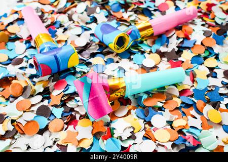 Party horns on colorful confetti stillife Stock Photo