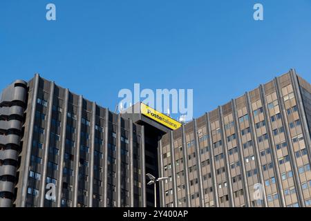 Poste Italiane (Italian Post) logo sign on the top of the large headquarters building. EUR district, Rome, Italy, Europe - Clear blue sky, copy space Stock Photo
