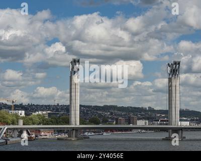 Bridge over a river, city in the background with cloudy sky, rouen, his, france Stock Photo