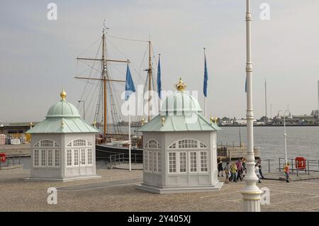 Two decorative pavilions at the harbour with a historic sailing boat in the background, copenhagen, denmark Stock Photo