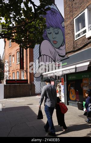 15 September 2024, London  London Mural Festival  A mural festival takes place across London throughout September 2024. Pictured is A Dog in Hand by D*Face, in Crowndale Road, Camden.  Photo Credit: Roland Ravenhill/Alamy Stock Photo