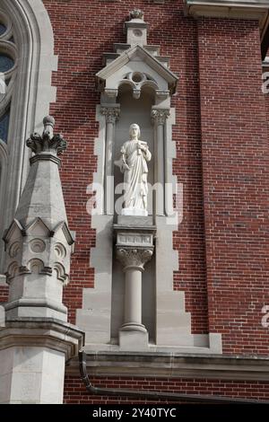 Looking up at the statue of St. Joseph next to The main entrance to the Basilica and National Shrine of Mary Help of Christians on Holy Hill in Hubert Stock Photo