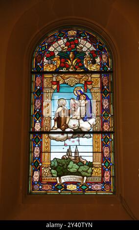 St. Therese interceding to the Queen of Saints stained glass in the Chapel of St. Therese located in the Basilica and National Shrine of Mary Help of Stock Photo