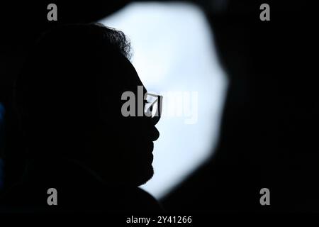 Mysterious silhouette of a man wearing glasses, side profile in soft light, creating a thoughtful and contemplative mood. Stock Photo