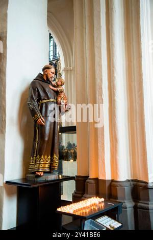 Baroque style interior of Our Lady Church in Bruges, Belgium and statue of Saint Stock Photo