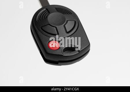 Emergency panic button on car key FOB. Vehicle alarm, security and safety system concept Stock Photo