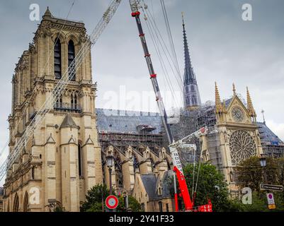 09 15 2024 - Paris, France. Notre Dame construction site with scaffoldings and cranes. Cathedral under construction after fire. Reconstruction process Stock Photo