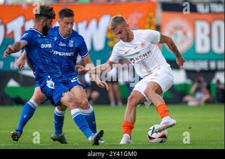 LUBIN, POLAND - AUGUST 17, 2024: Football match Polish PKO Ekstraklasa between KGHM Zaglebie Lubin vs Lech Poznan. Ali Gholizadeh (L)  Radoslaw Muraws Stock Photo