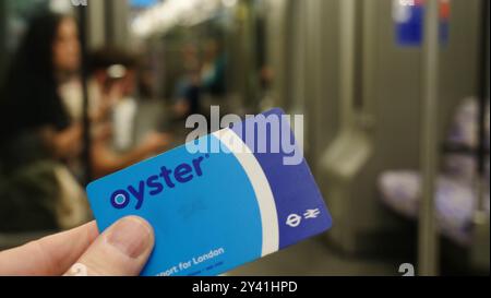 A Transport for London Oystercard against a background from the London Underground Stock Photo